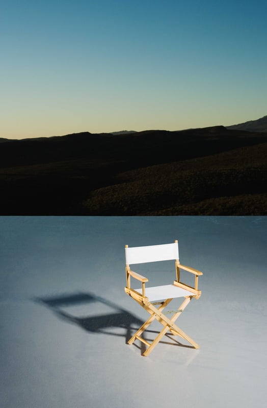 Directors-chair-on-platform-at-down,-mountains-in-background