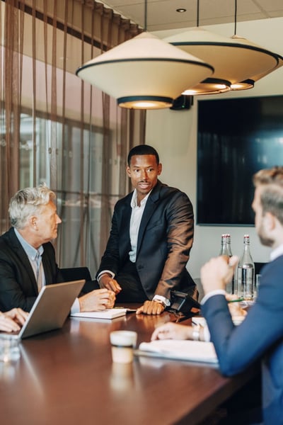 Male business professional discussing strategy with colleagues_resize