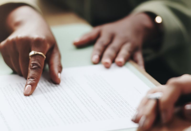 business-people-hands-and-pointing-on-contract-for-legal-documents-application-and-agreement-in-office-cropped-800x550