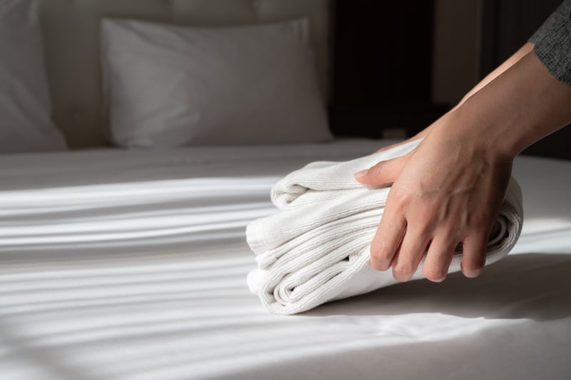 hands arranging the stack of towels