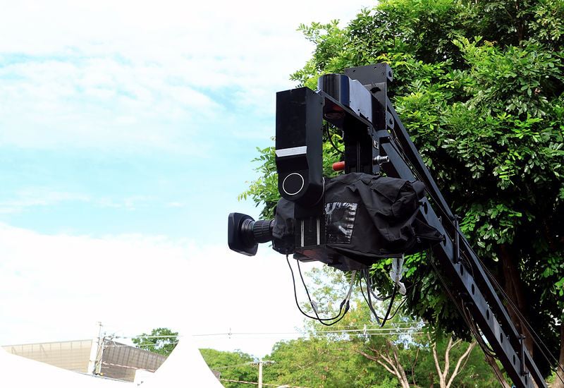 tv-or-cinema-camera-installed-in-a-crane-protected-by-a-plastic-rain-cover-800x550